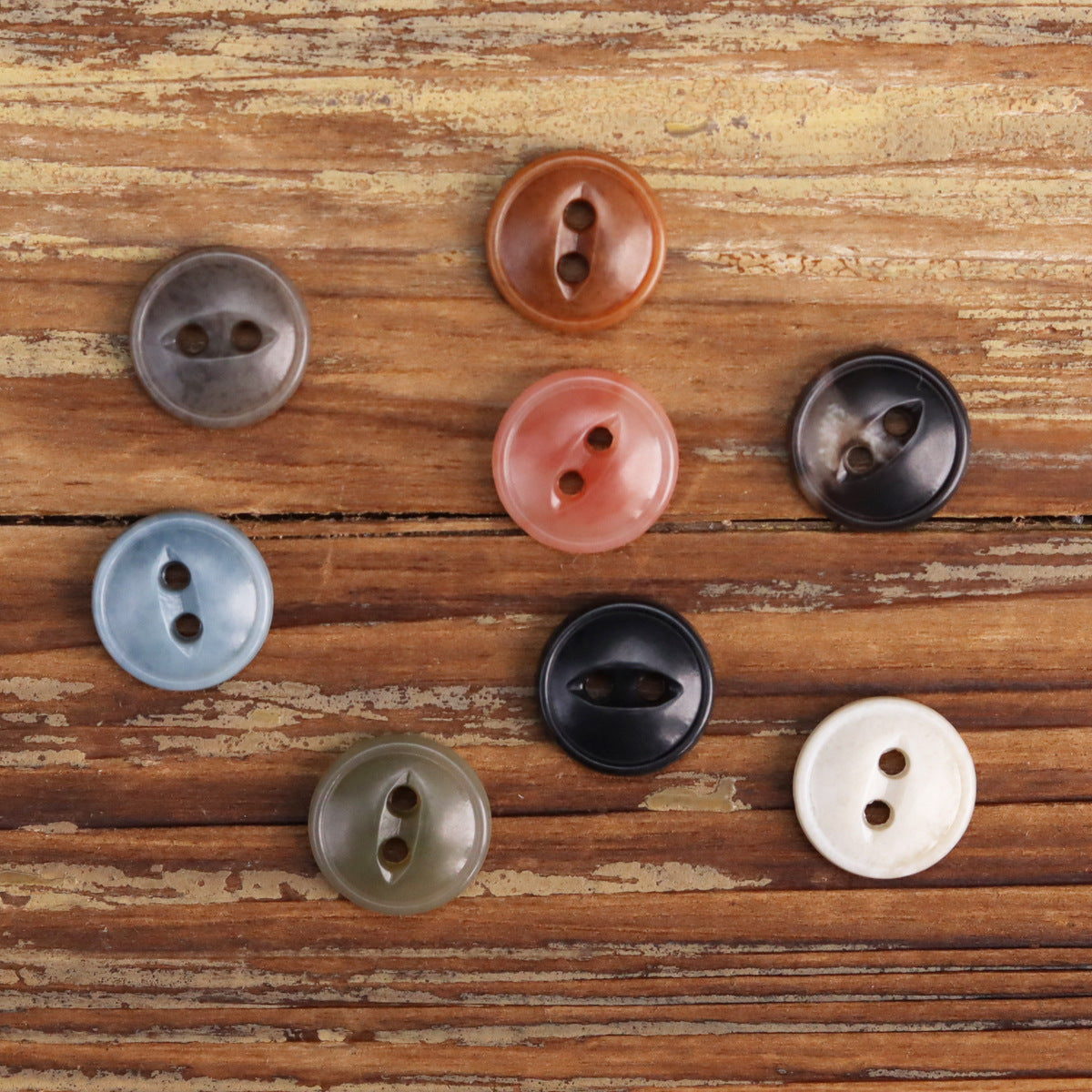 Round two-eye urea buttons, 2-hole design in black, light blue, orange, and white