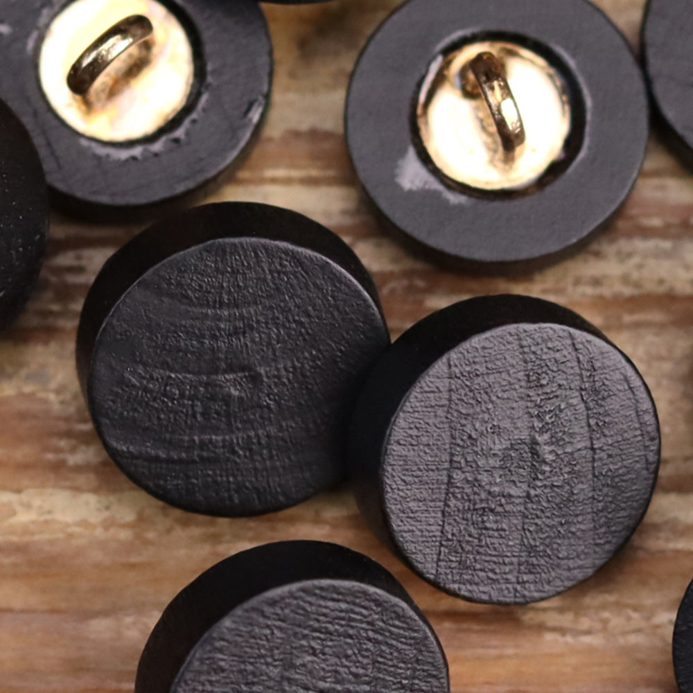 Set of black flat wooden buttons with gold-toned metal loops on the front