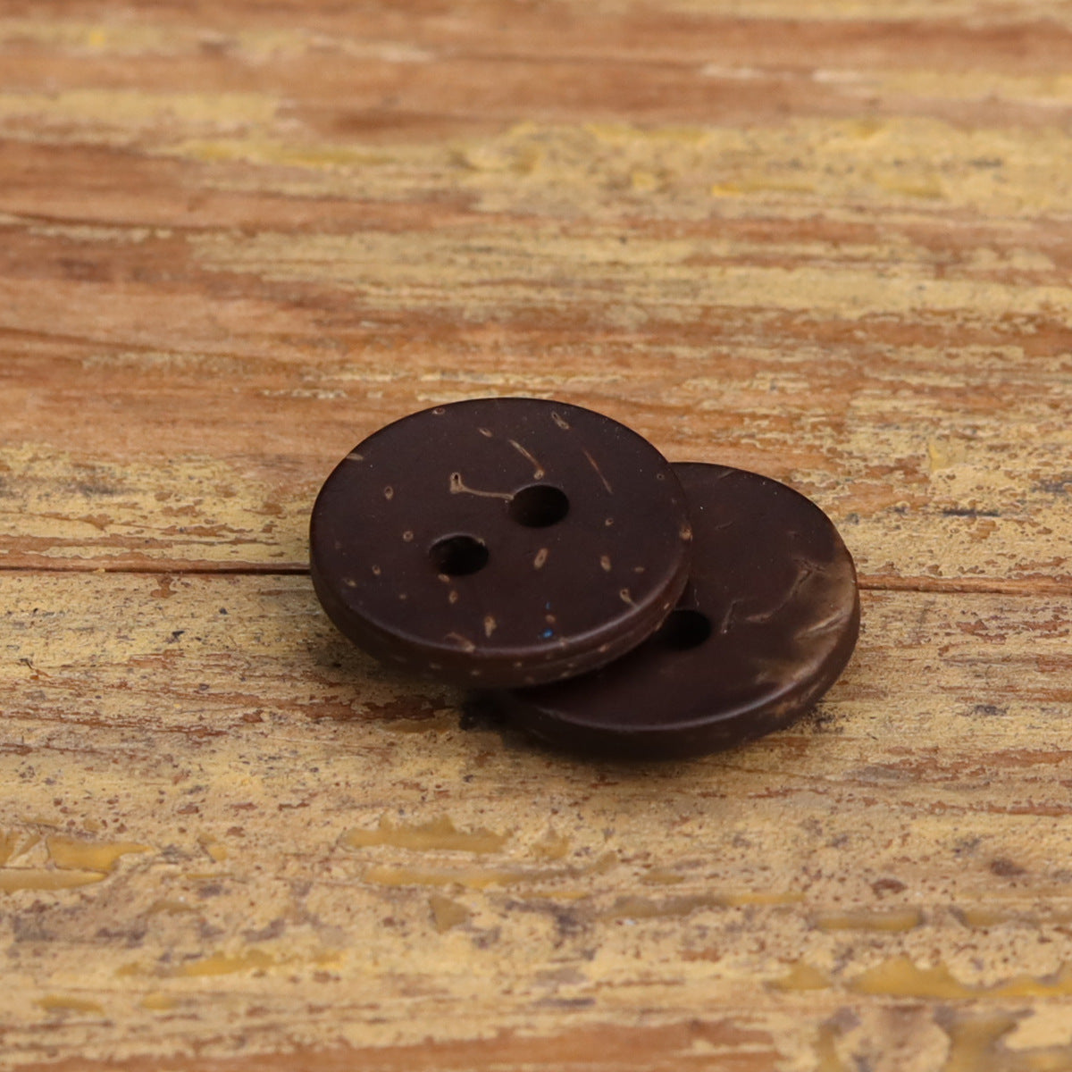 Coffee-bean brown coconut shell two-hole buttons, two pieces with dark dot holes