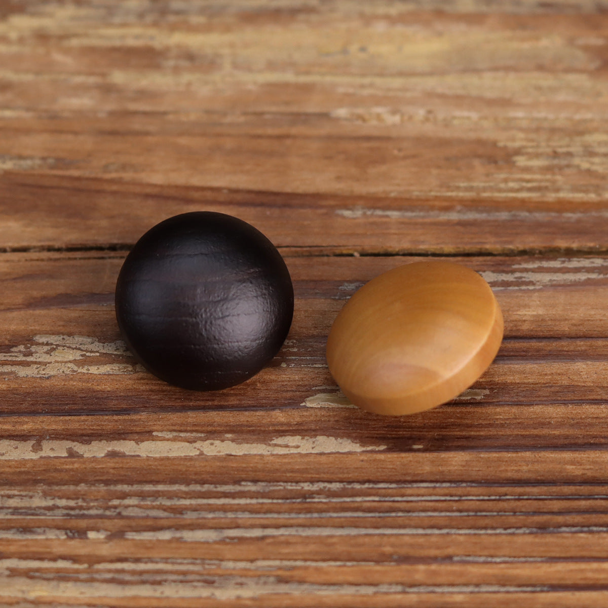Two deep wooden buttons, dark brown and light tan, front view