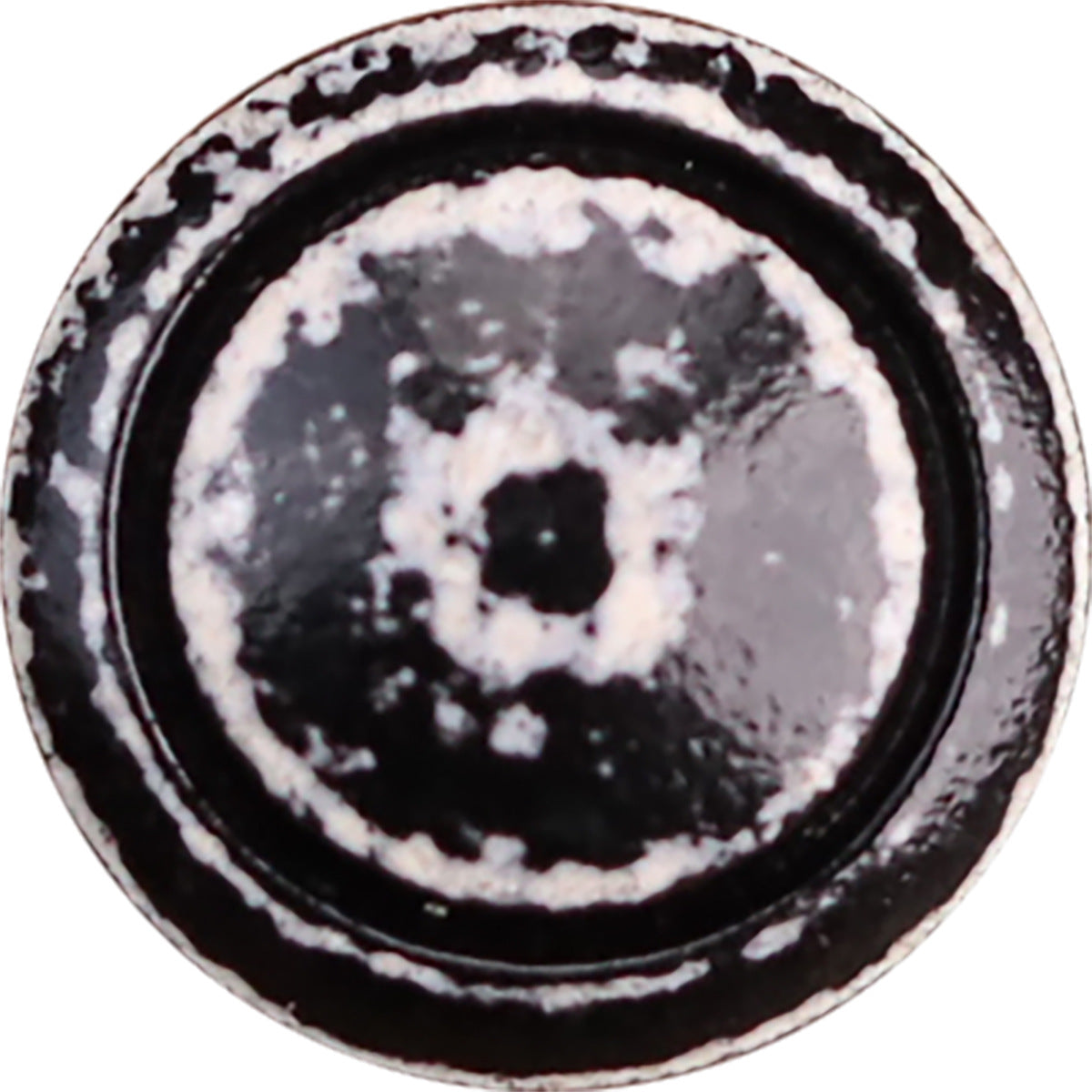 Vintage distressed black-and-white lacquered wooden button, round with worn speckle detail