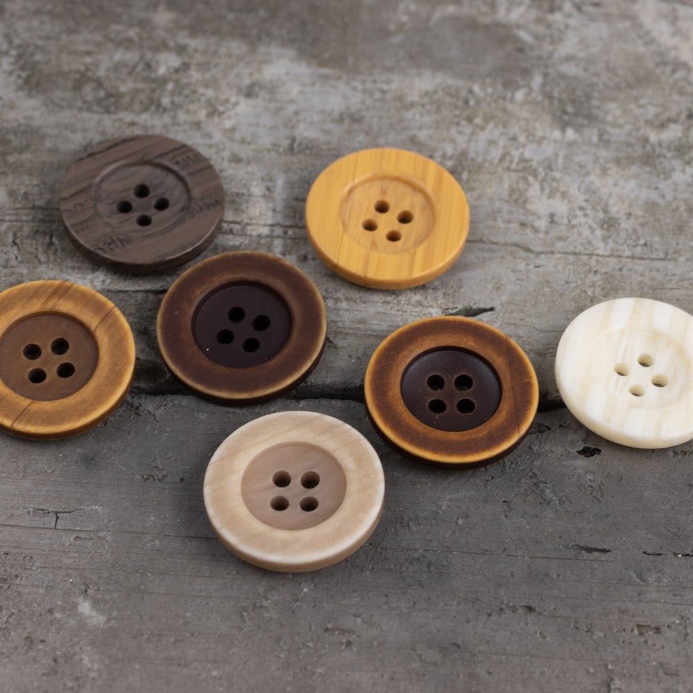 Yellow imitation wood-grain resin button with four-hole design, round face