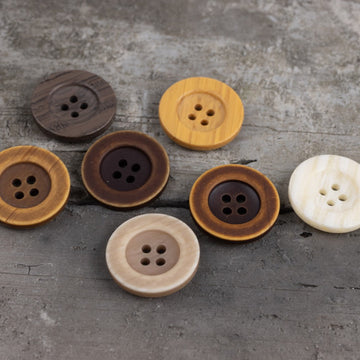 Yellow imitation wood-grain resin button with four-hole design, round face