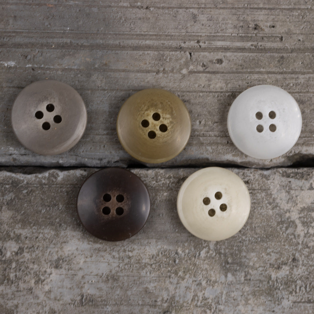 Set of round matte resin buttons with 4 holes in grey, olive, and white tones