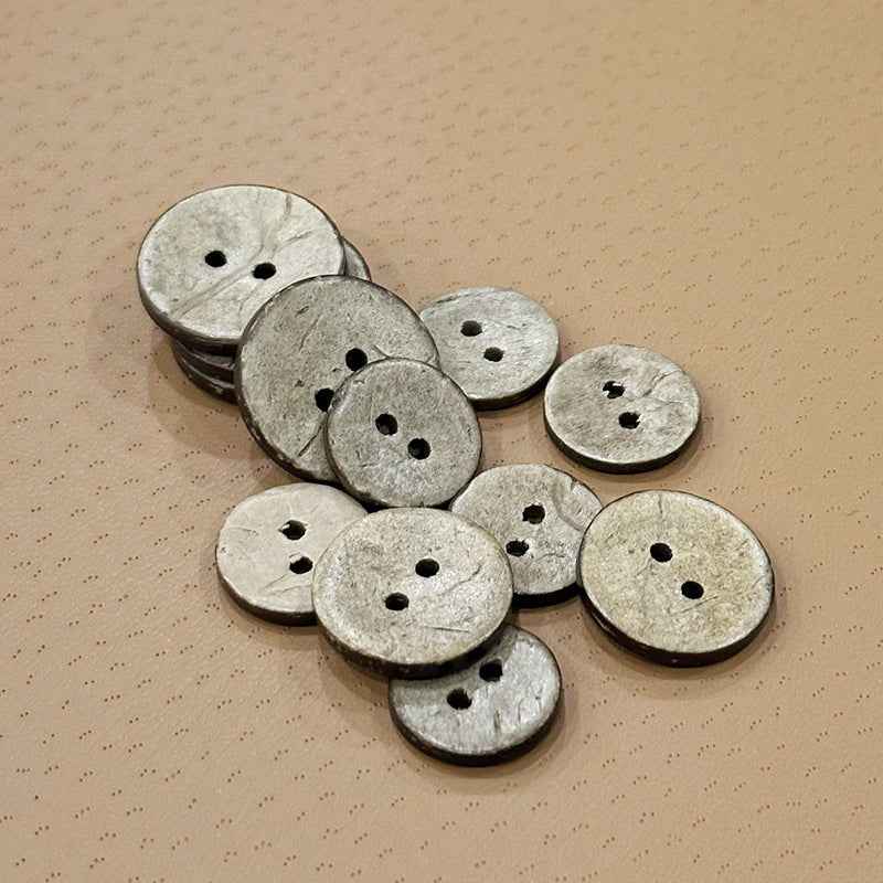Round coconut shell buttons with two holes, light gray, assorted diameters (9–30mm), bulk pack