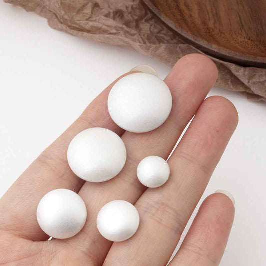 White round pearl buttons with metal shank, small to large set in hand