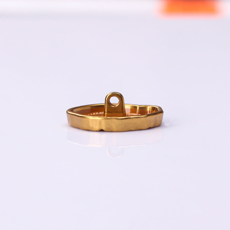 Antique gold metal button side view with raised shank loop