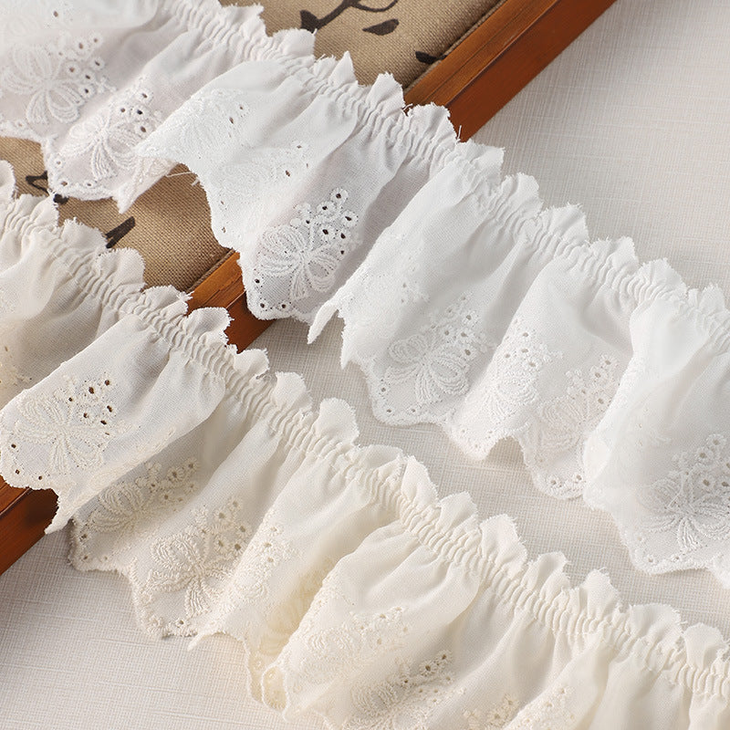 Off-white cotton pleated lace trim featuring butterfly embroidery bands and ruffled hem