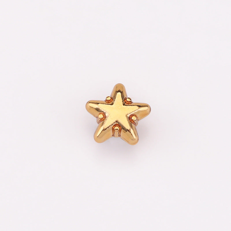 Gold-tone star metal shank shirt button with decorative red insets
