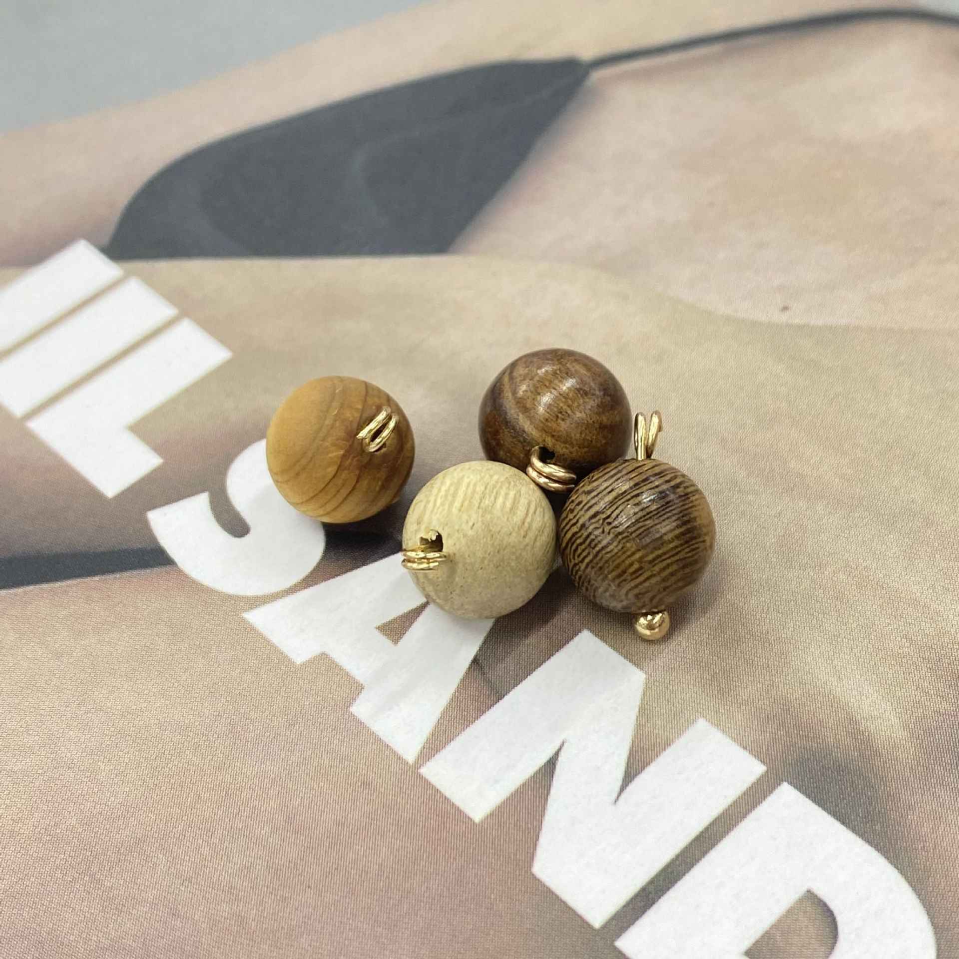 Round wooden Chinese qipao buttons in brown tones, gold-tone loops