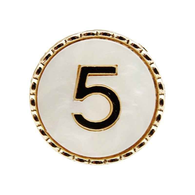 Gold-trimmed Number 5 resin shank button, white face with black “5”