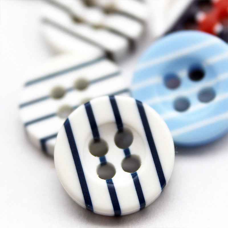White resin button with navy vertical stripes and four holes