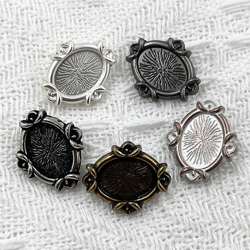 Set of oval metal shank buttons with engraved floral pattern in silver, black, dark, and gold