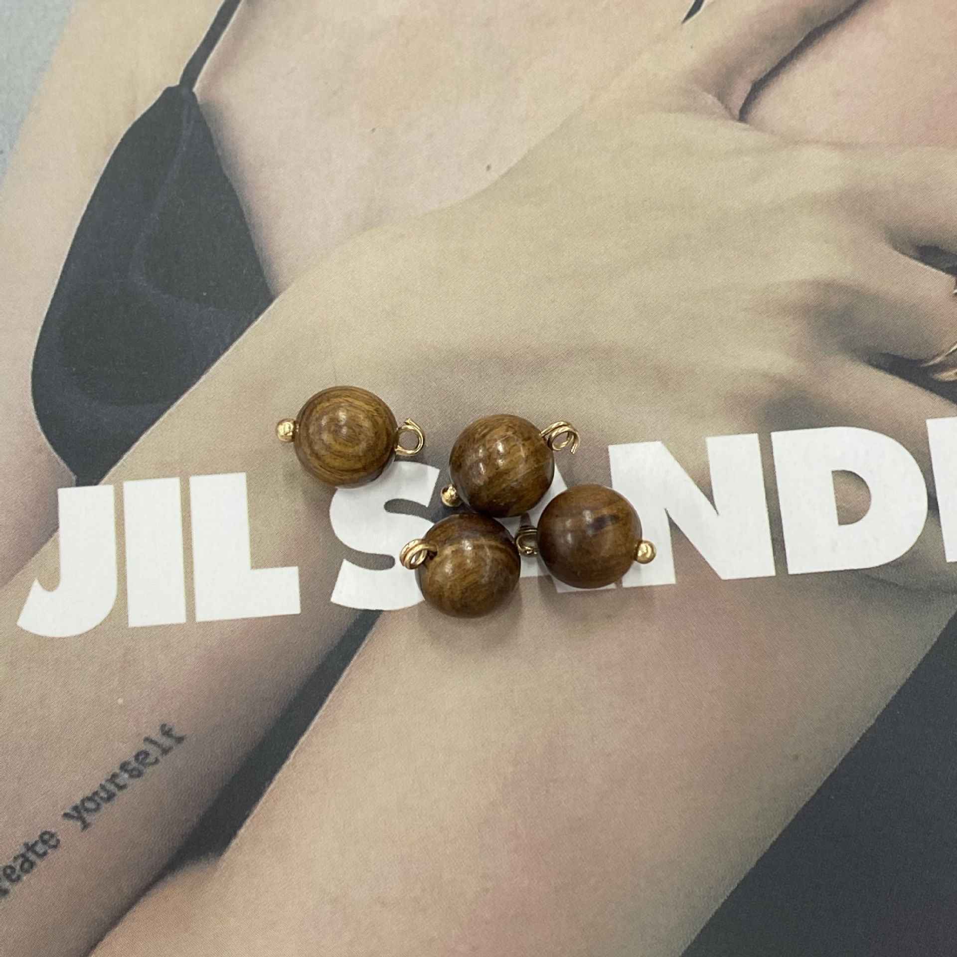 Deep brown round wooden buttons with gold-tone loops