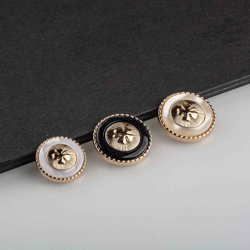 Four-leaf clover resin buttons with gold trim and metal shanks, three-piece view