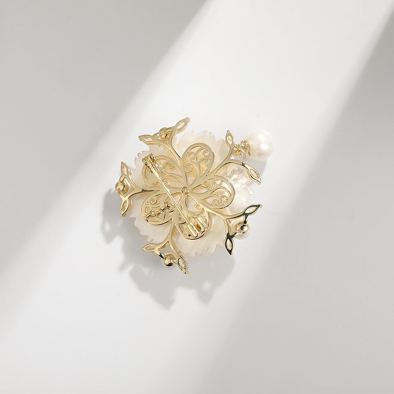 Gold-tone camellia pearl pin with delicate leafwork and white pearl accents