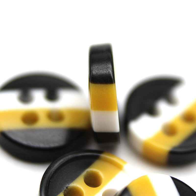 Stack of round 4-hole resin buttons, black top, yellow band, white center