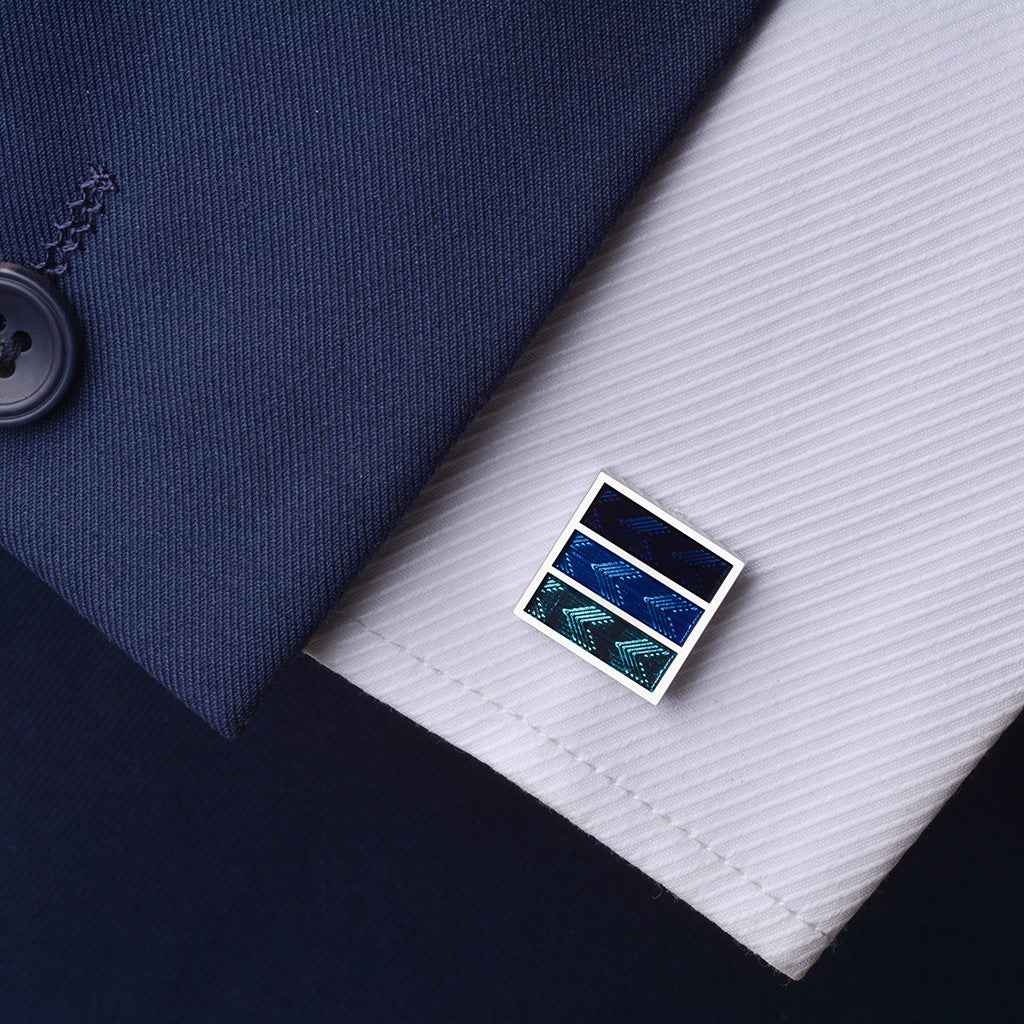 Square French cufflinks with blue, teal, and dark blue arrow stripe pattern