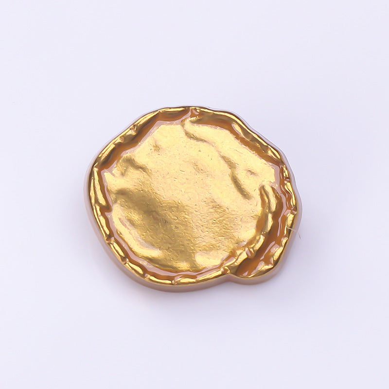 Antique gold irregular concave metal button face with raised rim detail