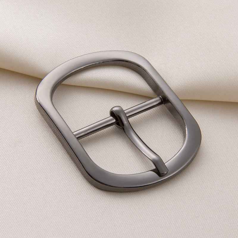 Gunmetal center-bar belt buckle with pin adjustable fastener, close-up