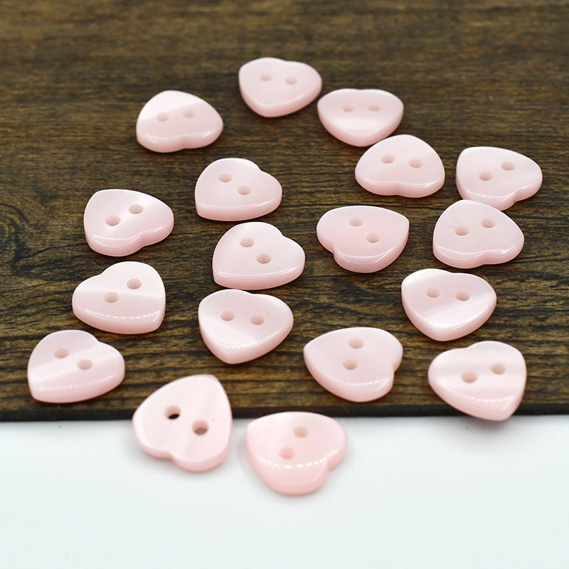 Pale pink resin heart buttons with two holes, assorted pieces