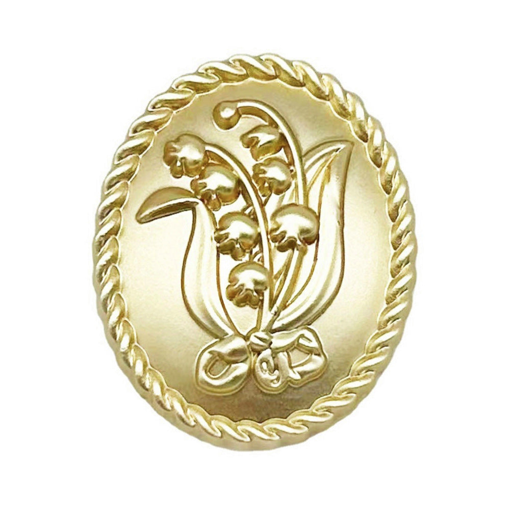 Ovaler Metallknopf „Lilie des Tal“ in Sand Gold, 18/23 mm