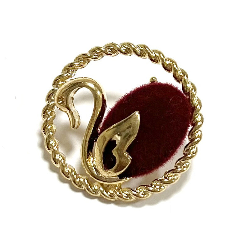 Red swan flocked button with gold edge and metal shank, oval floral detail
