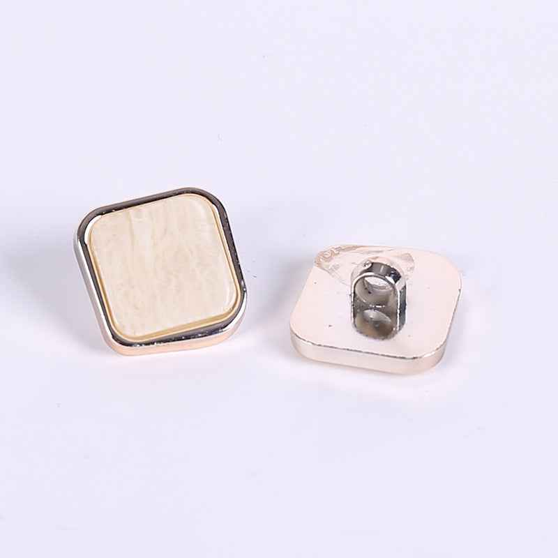 Rose gold square beveled plastic button with light marble face and metal shank back