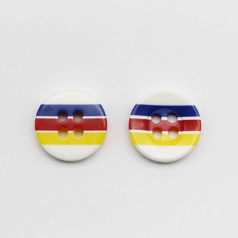 Two round resin buttons with 4 holes, candy stripes: blue, red, yellow on white