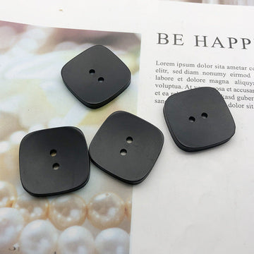 Black square resin coat buttons, two-hole design (30-pack).