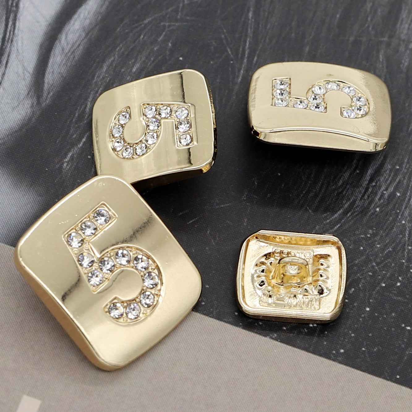 Number 5 shank buttons in gold tone with clear rhinestones