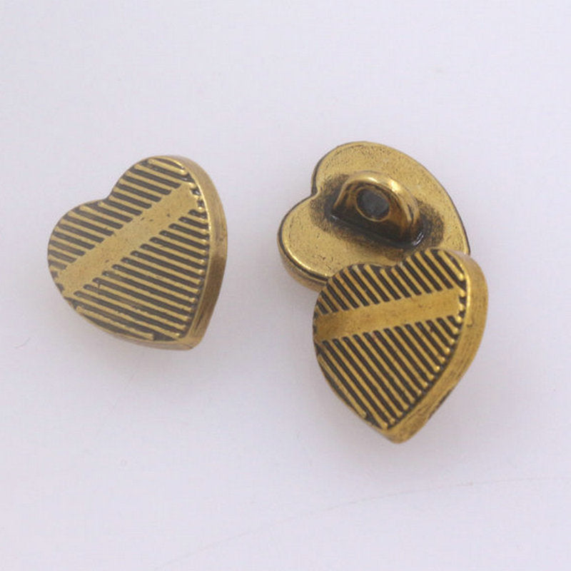 Vintage gold heart metal shank button with striped ridges and button shank