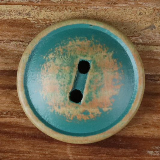 Round teal wood 2-hole button with two dark holes, close-up