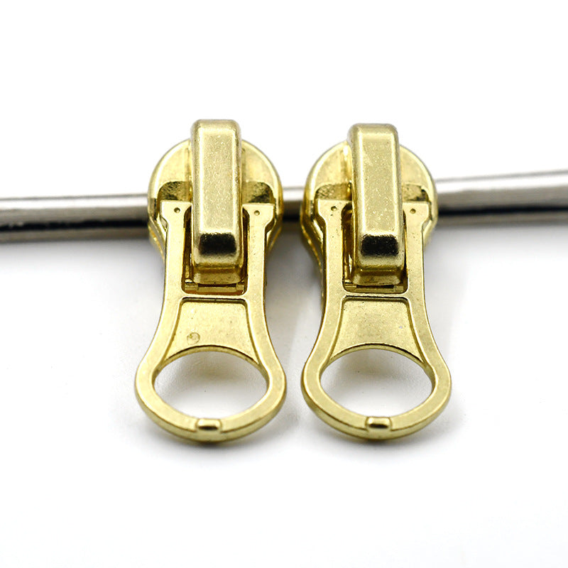 Two heavy-duty metal zipper pulls (#4) in gold finish, with round ring tab