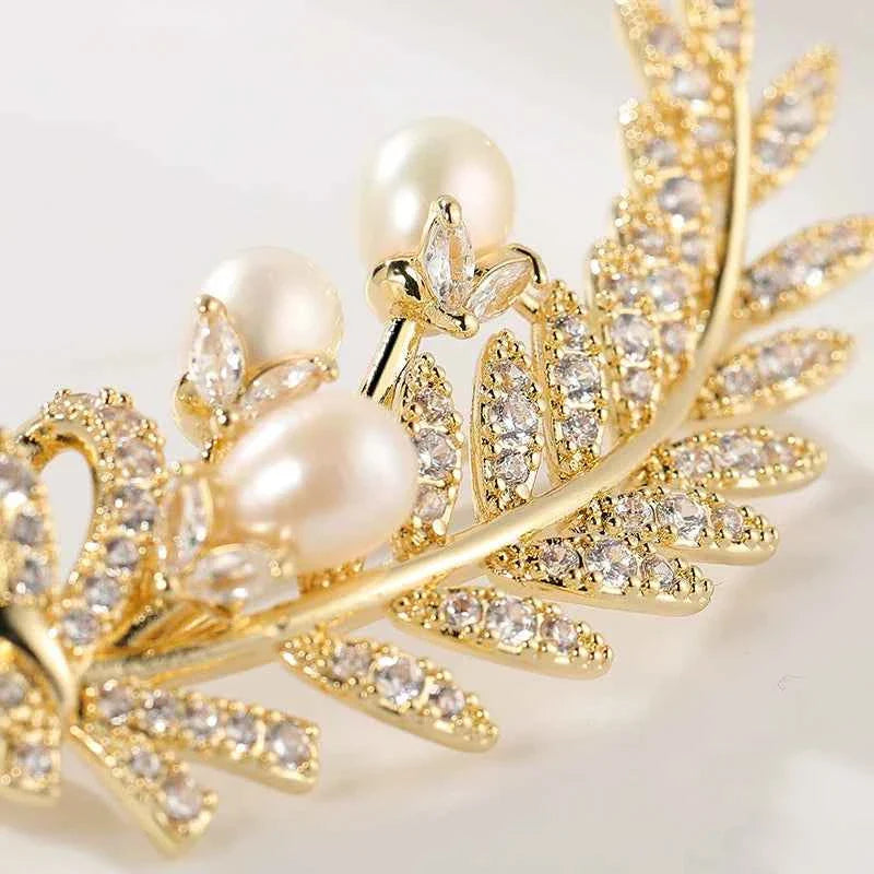 Gold wheat leaf brooch pin close-up with zircons and natural pearl accents