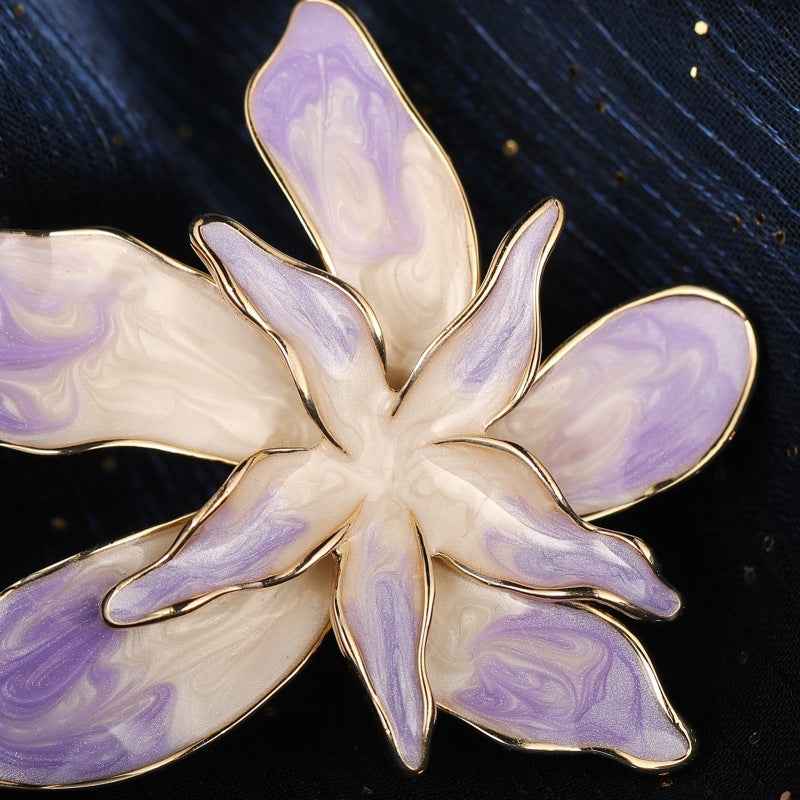 Close-up orchid brooch pin, lilac enamel petals with gold-edged flower center