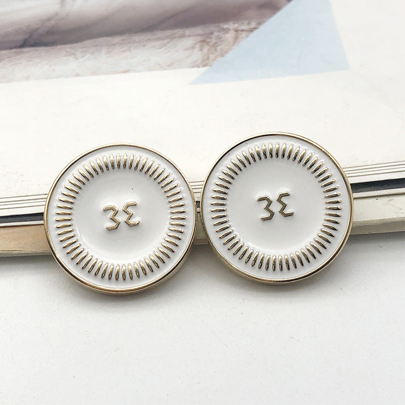 Style 2 round gold metal shank button, raised symbol on light face, 18mm