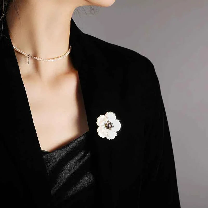 Shell flower rhinestone brooch on dark outfit, round pearl center with gold setting
