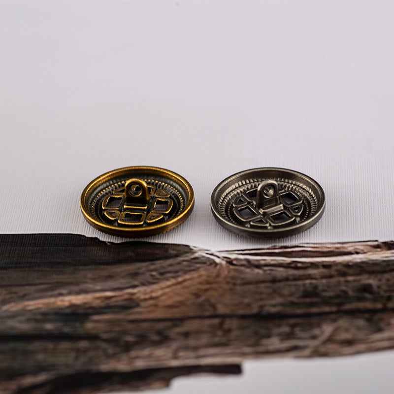 Two round metal shank buttons: antique gold and antique silver, cross grille with center loop.