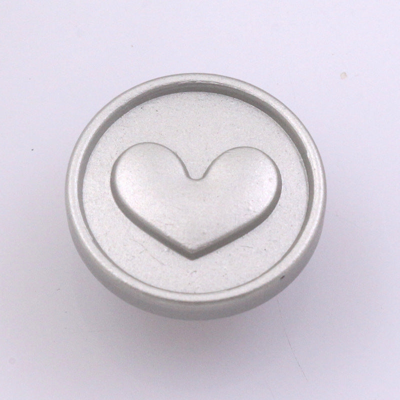 Silver 17mm stud button with raised heart pattern, smooth flat back