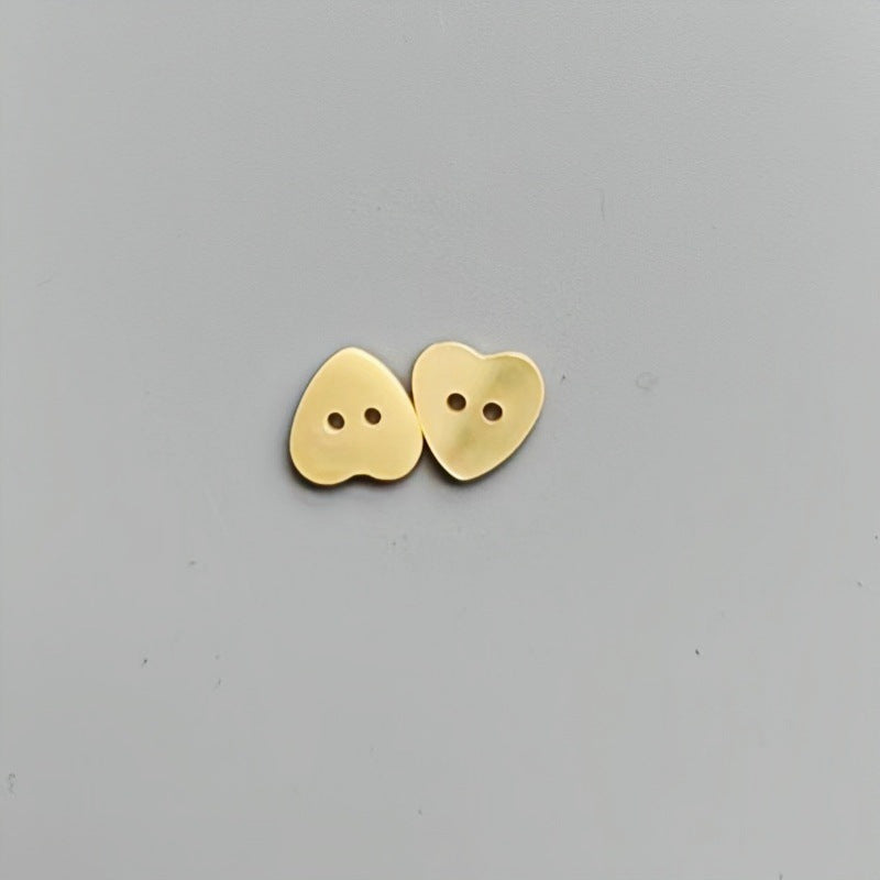 Yellow heart-shaped 2-hole shirt buttons for children, two buttons shown.
