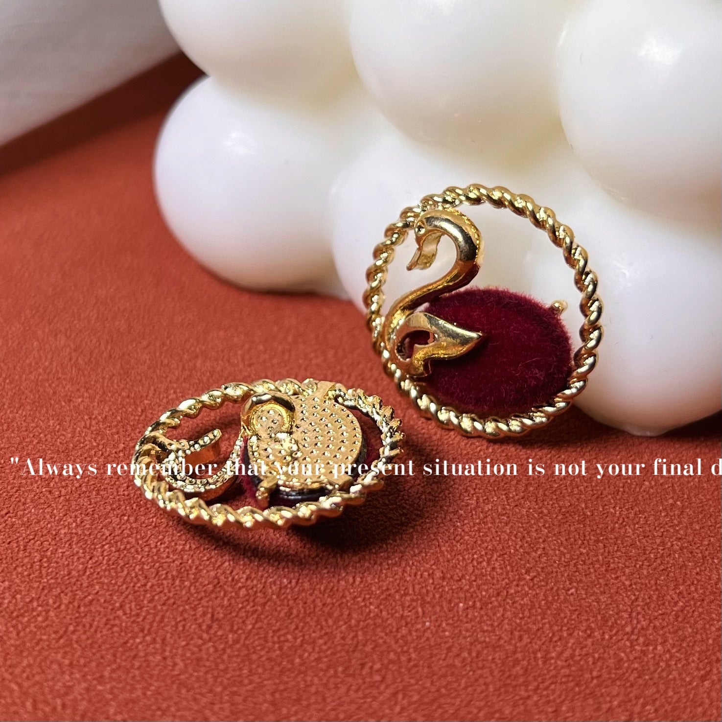 Flocked swan buttons with gold edge and metal shank; red and black close-up