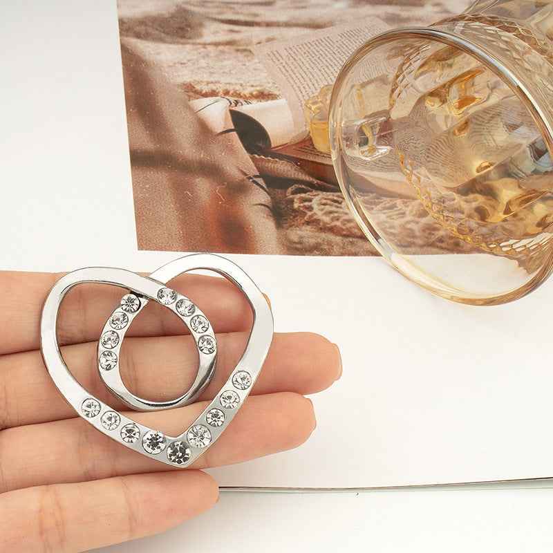Heart-shaped button with crystal-studded border, silver tone for tops or scarves