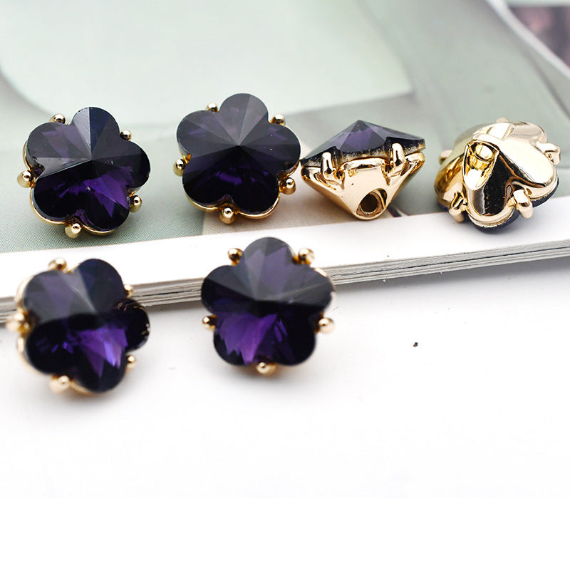 Small flower glass rhinestone shank buttons, dark purple flower faces with gold-tone settings and metal shanks