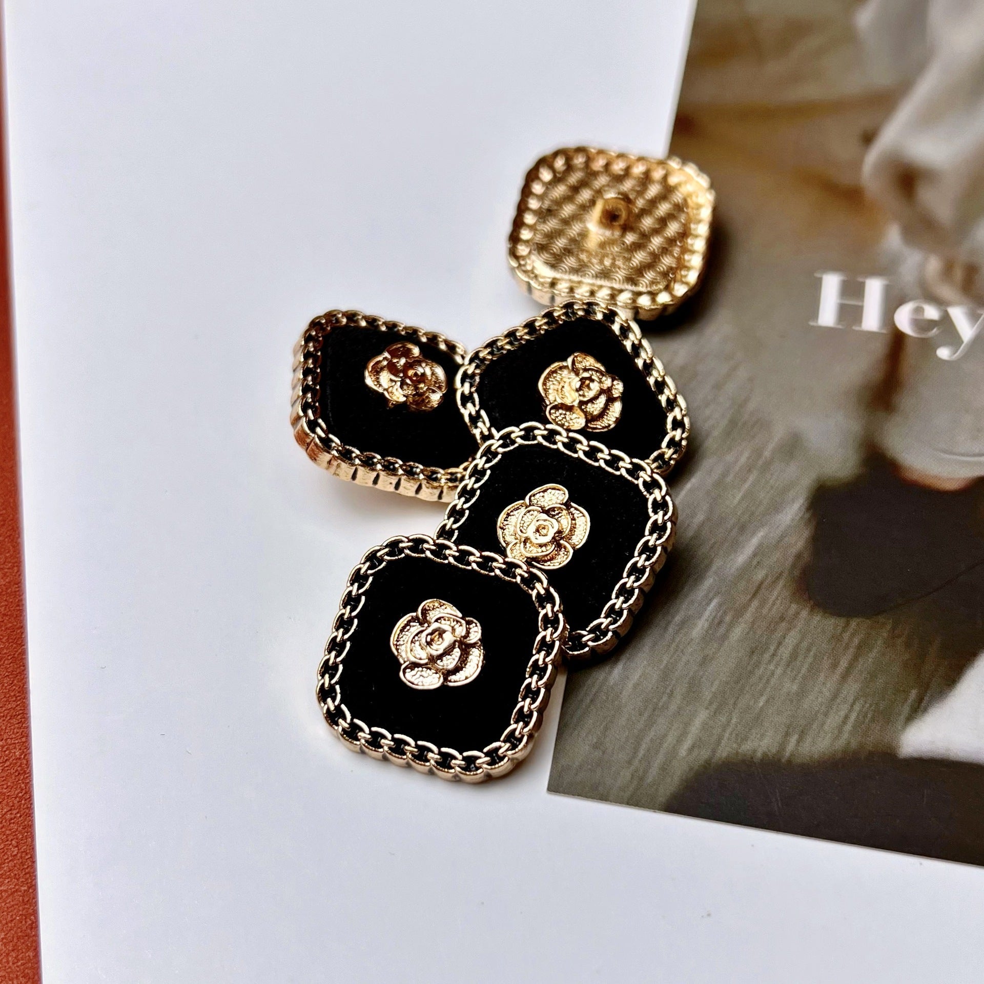 Vintage square buttons, black flocked with gold rose motif and metal chain border