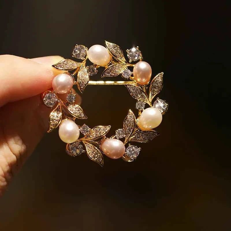 Freshwater pearl wreath brooch pin with gold-tone leaves and rhinestone accents
