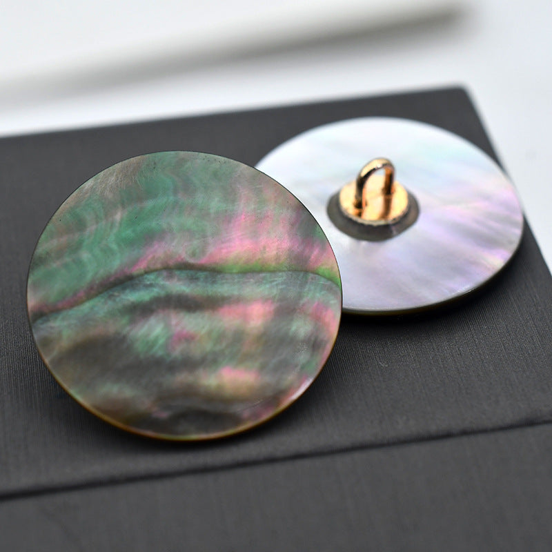 Iridescent green-pink shell round buttons with metal shank, two-button view