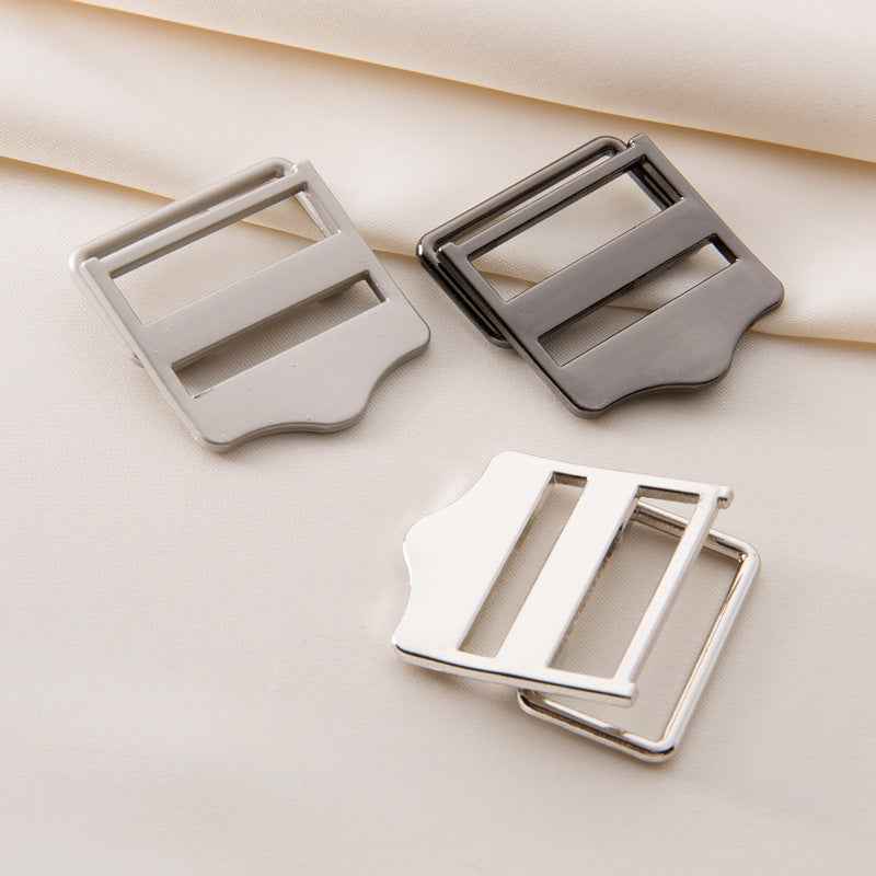 Metal strap adjuster buckles in light set: white/cream, dark gray, and rose-gold tone