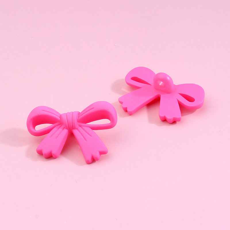 Hot pink bow-shaped plastic shank buttons with loop shanks, 2-piece view