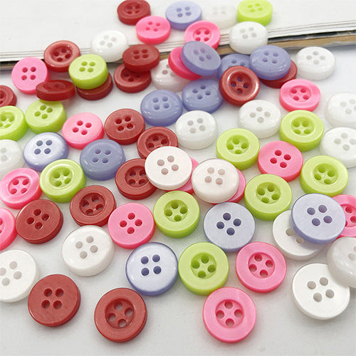 Assorted round pearlized 4-hole resin buttons, close-up (10mm)